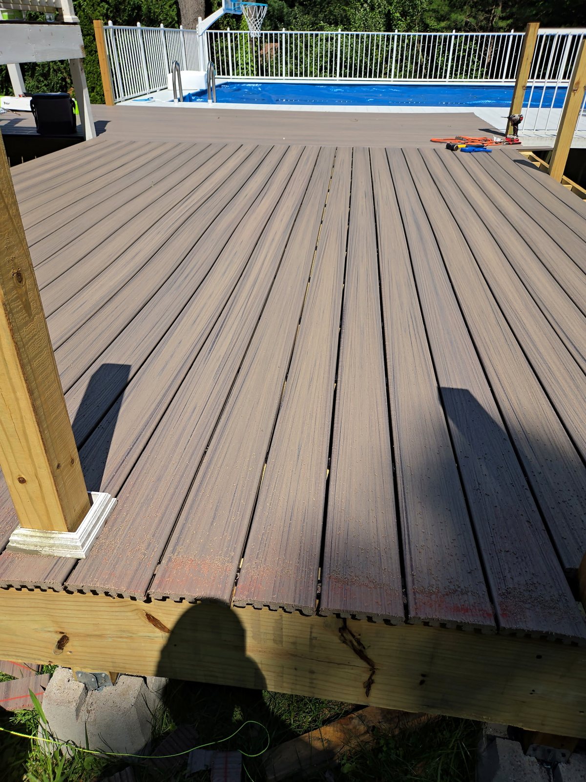 Composite deck boards installed around a Rhode Island pool deck