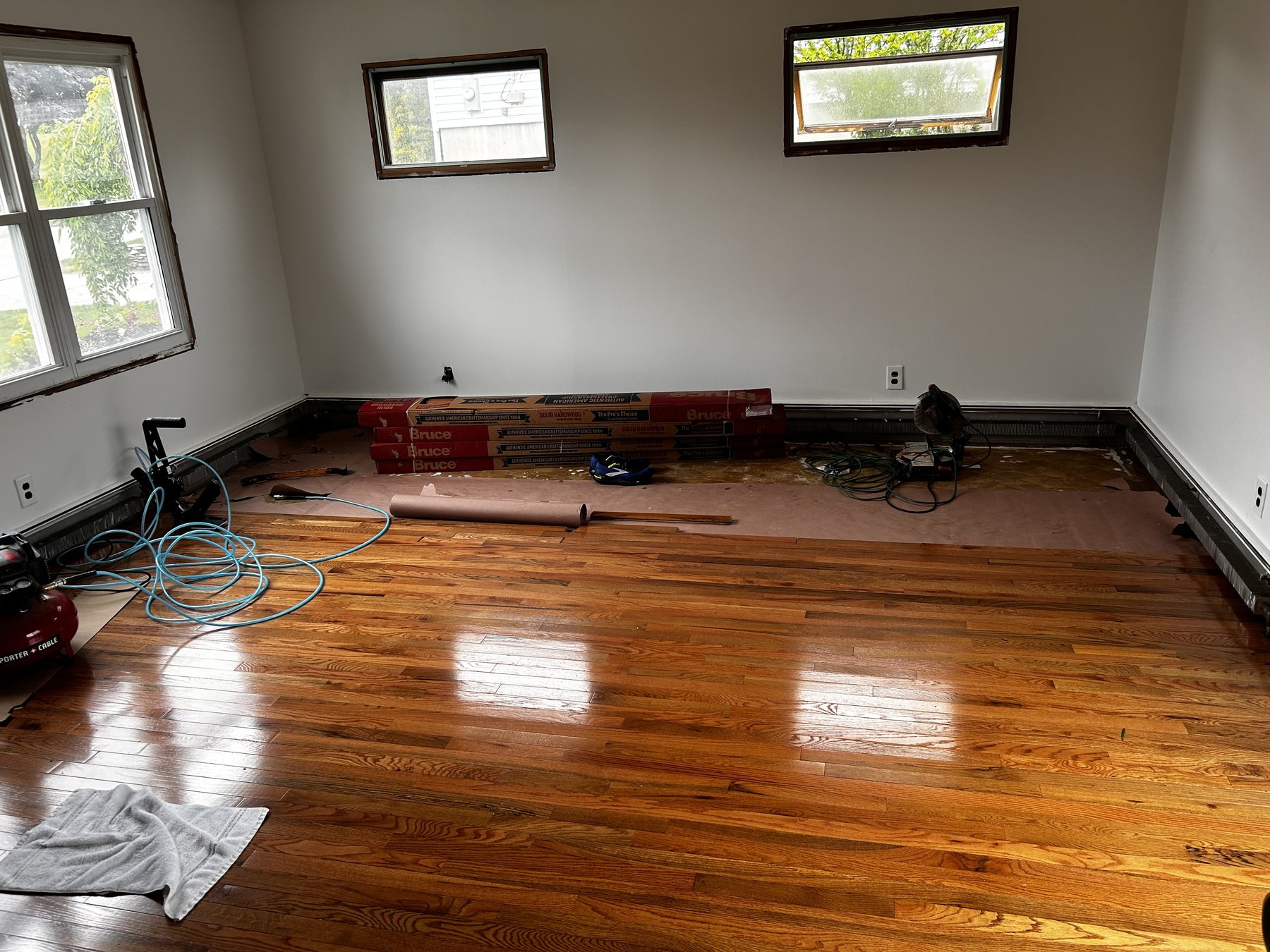 Cook Flooring & Tile crew installing a hardwood floor on a Rhode Island job site