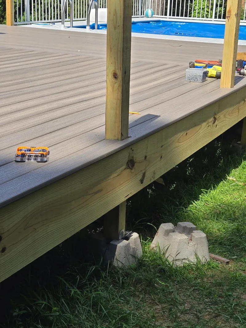 Composite deck boards installed over a newly framed deck edge