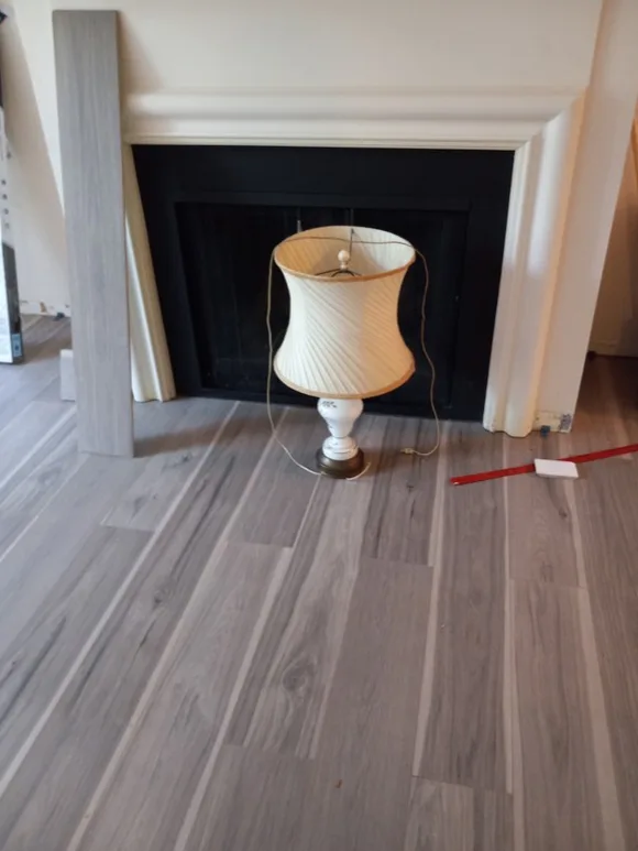 LVP flooring fitted around a black fireplace hearth