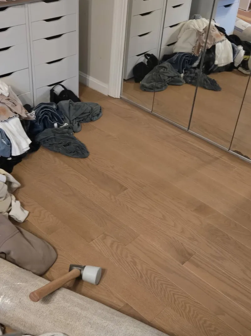 White oak flooring fitted neatly along a mirrored closet track