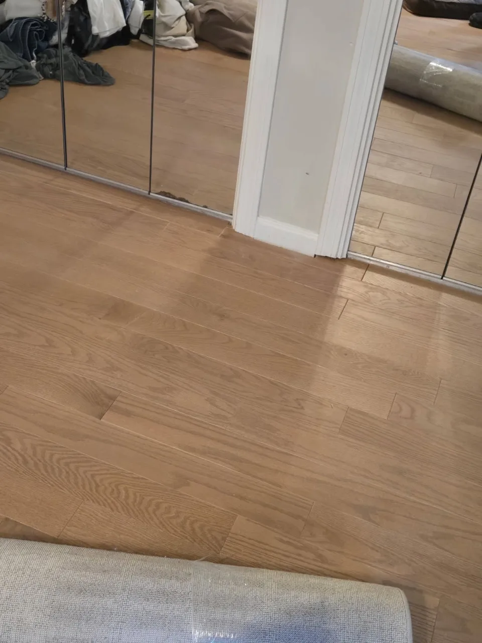Close view of clean white oak flooring fitted at a doorway transition