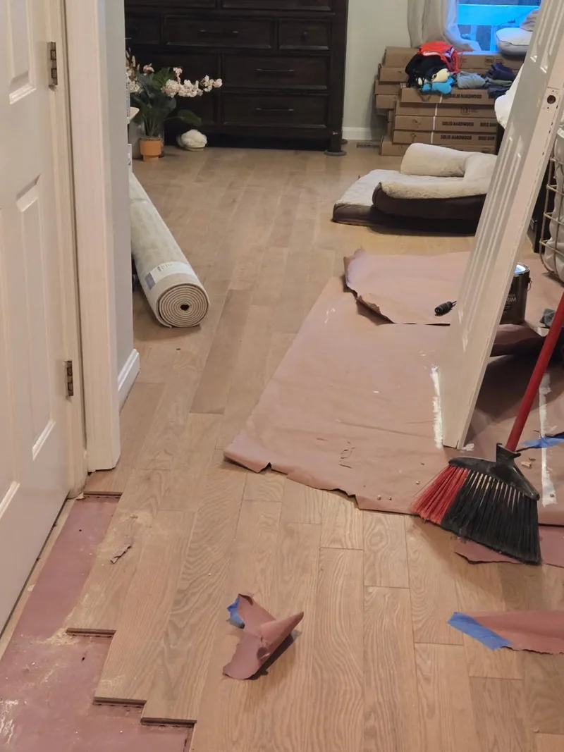 White oak flooring installed continuously through a hallway and doorway