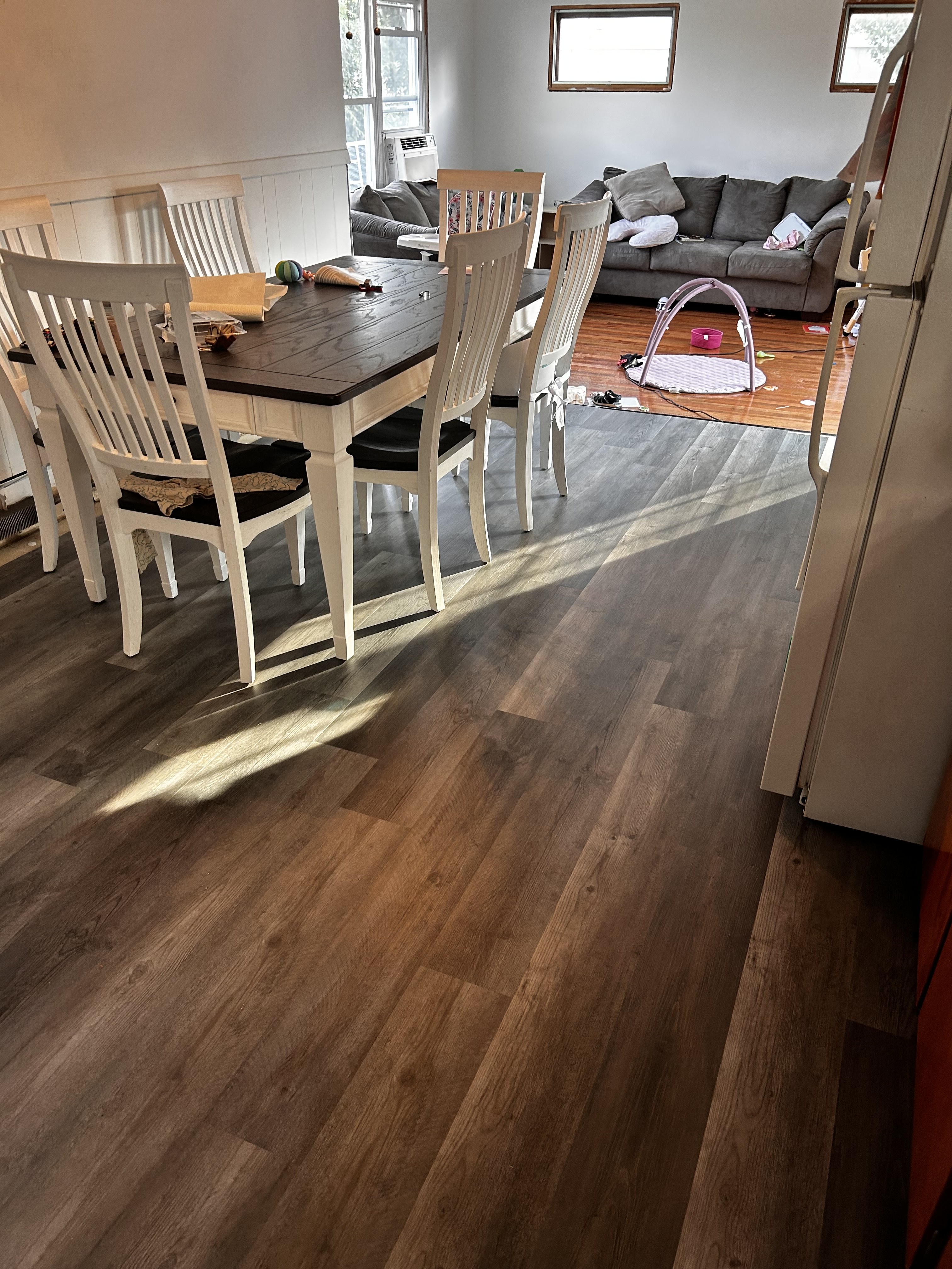 Finished kitchen and living room floor with wide plank LVP flooring