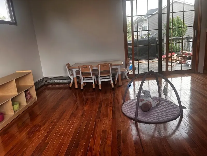 Finished hardwood floor extending across a bright living room
